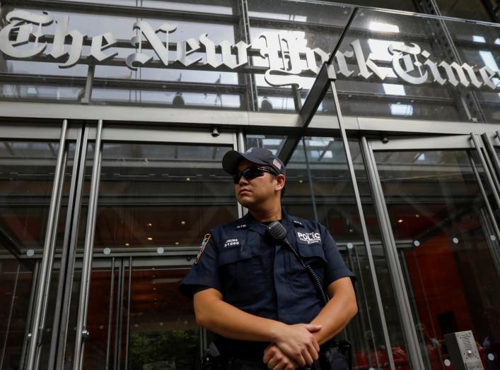 A New York Police officer is seen deployed outside the New York Times building following a fatal shooting at a Maryland newspaper, in New York City, U.S., June 28, 2018. REUTERS/Brendan McDermid
