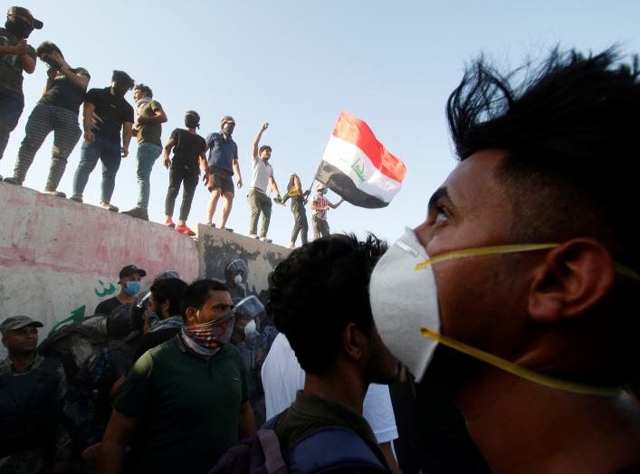 Iraqi protesters stand on concrete blast walls during a protest near the building of the government office in Basra, Iraq September 6, 2018. REUTERS/Essam al-Sudani