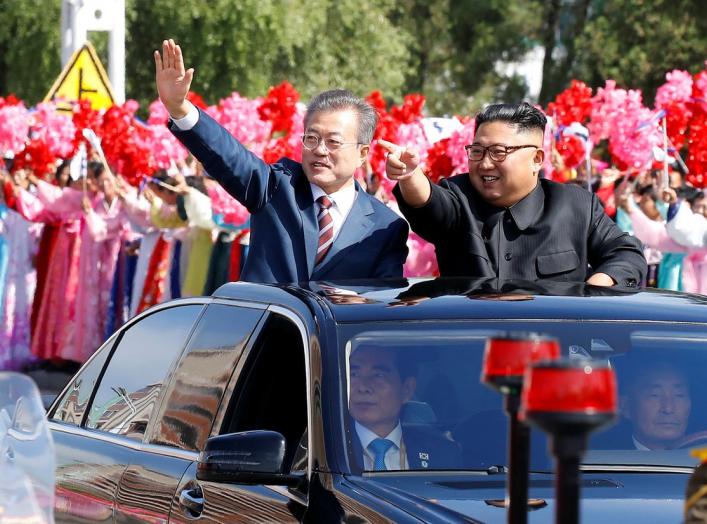 South Korean President Moon Jae-in and North Korean leader Kim Jong Un wave during a car parade in Pyongyang, North Korea, September 18, 2018. Pyeongyang Press Corps/Pool via REUTERS