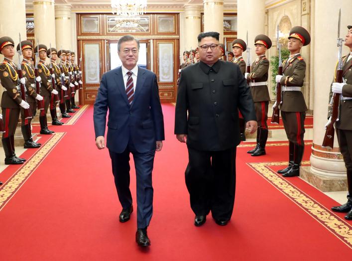 South Korean President Moon Jae-in is greeted by North Korean leader Kim Jong Un as he arrives at the headquarters of the Central Committee of the Workers' Party of Korea for their meeting in Pyongyang, North Korea, September 18, 2018. Pyeongyang Press Co