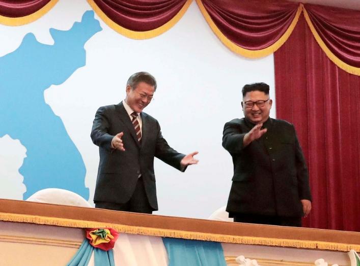 South Korean President Moon Jae-in talks with North Korean leader Kim Jong Un as they watch an art performance at Pyongyang Grand Theatre in Pyongyang, North Korea, September 18, 2018. Pyeongyang Press Corps/Pool via REUTERS