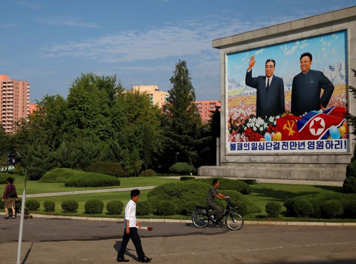 Residents pass by a painting of late North Korean leaders Kim Il Sung and Kim Jong Il in Pyongyang, North Korea, September 6, 2018. REUTERS/Danish Siddiqui 