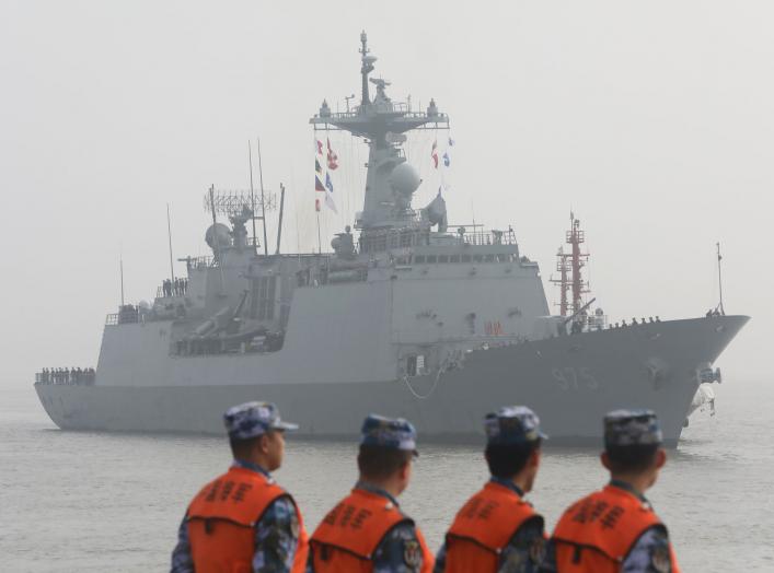 Chinese People's Liberation Army (PLA) Navy officials stand guard as a South Korean naval ship approaches the dock in Shanghai, China January 14, 2019. REUTERS/Stringer ATTENTION EDITORS - THIS IMAGE WAS PROVIDED BY A THIRD PARTY. CHINA OUT.