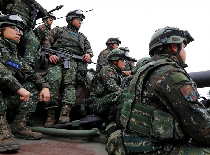 Soldiers sit on an M60A3 tank for a group photograph after an anti-invasion drill to test readiness ahead of Lunar New Year, simulating enemy invasion and the safeguarding of the weapon systems in case of air raid, in Taichung, Taiwan January 17, 2019. RE