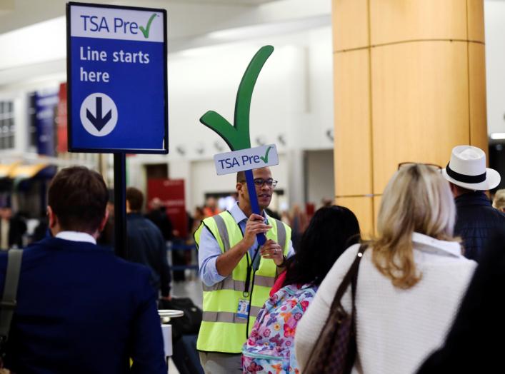 A man guides passengers towards a Transportation Security Administration (TSA) PreCheck security checkpoint at Hartsfield-Jackson Atlanta International Airport amid the partial federal government shutdown, in Atlanta, Georgia, U.S., January 18, 2019.