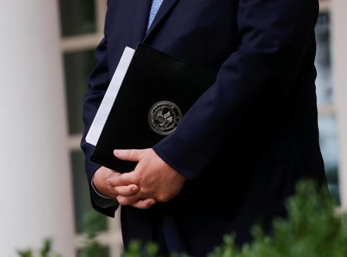 U.S. Attorney General Bill Barr stands with a copy of his remarks in his hands before announcing the Trump administration's effort to gain citizenship data during the 2020 census at an event with the president in the Rose Garden of the White House