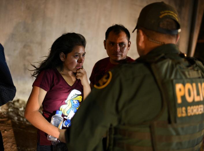 Thirteen year-old Joseline, a Guatemalan migrant seeking asylum with father Jose Luis, cries after crossing the Rio Grande and turning herself in to U.S. Border Patrol in Hidalgo, Texas, U.S., August 23, 2019. Picture taken August 23, 2019. REUTERS/Loren 