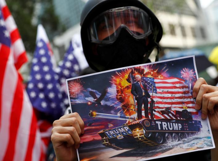 A protester holds up a sign featuring U.S. President Donald Trump in Central, Hong Kong, China September 8, 2019. REUTERS/Kai Pfaffenbach NO RESALES. NO ARCHIVES.