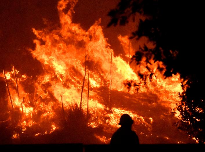 Firefighters battle a wind-driven wildfire called the Saddle Ridge fire in the early morning hours Friday in Porter Ranch, California, U.S., October 11, 2019. REUTERS/Gene Blevins