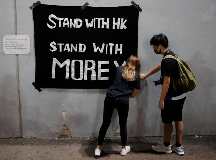 Protesters hang a banner during a gathering in support of NBA's Houston Rockets' team general manager Daryl Morey, who sent a tweet backing the pro-democracy movement, in Hong Kong, China, October 15, 2019. REUTERS/Umit Bektas