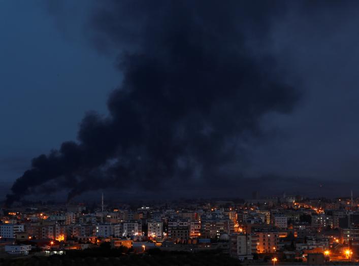 Smoke rises over the Syrian town of Ras al Ain, as seen from the Turkish border town of Ceylanpinar, in Sanliurfa province, Turkey, October 16. REUTERS/Murad Sezer