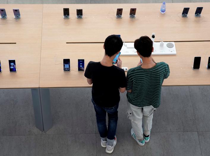 People look at smartphones in Huawei's first global flagship store in Shenzhen, Guangdong province, China October 30, 2019. REUTERS/Aly Song