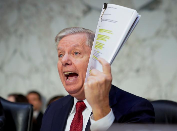 U.S. Senate Judiciary Committee Chairman Senator Lindsey Graham (R-SC) holds a copy of an intelligence report on the Steele dossier as he delivers an opening statement prior to hearing testimony from Justice Department Inspector General Michael Horowitz