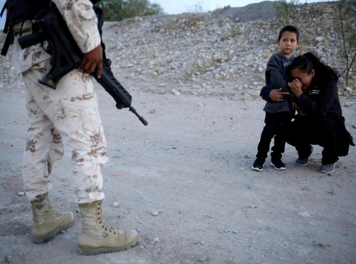 Guatemalan migrant Ledy Perez embraces her son Anthony while praying to ask a member of the Mexican National Guard to let them cross into the United States, as seen from Ciudad Juarez, Mexico, July 22, 2019. Reuters Photographer Jose Luis Gonzalez