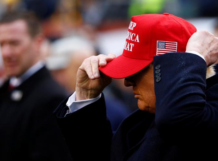 U.S. President Donald Trump puts on a Keep America Great hat during the annual Army-Navy collegiate football game at Lincoln Financial Field in Philadelphia, PA, U.S., December 14, 2019. REUTERS/Tom Brenner