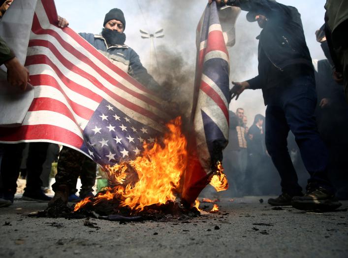 Demonstrators burn the U.S. and British flags during a protest against the assassination of the Iranian Major-General Qassem Soleimani, head of the elite Quds Force, and Iraqi militia commander Abu Mahdi al-Muhandis who were killed in an air strike