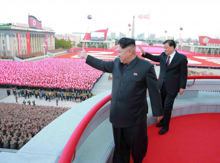 North Korean leader Kim Jong Un (L) and senior Chinese Communist Party official Liu Yunshan (R) wave during celebration of the 70th anniversary of the founding of the ruling Workers' Party of Korea, in this undated photo released by North Korea's Korean C