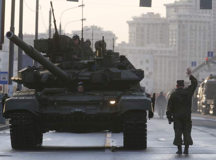 Russian servicemen are seen onboard a T-90 tank in a street before a rehearsal for the Victory Day parade in Moscow, Russia, April 29, 2015. Russia will celebrate the 70th anniversary of the victory over Nazi Germany in World War Two on May 9.