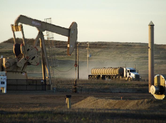 DATE IMPORTED:July 14, 2015A service truck drives past an oil well on the Fort Berthold Indian Reservation in North Dakota, November 1, 2014.
