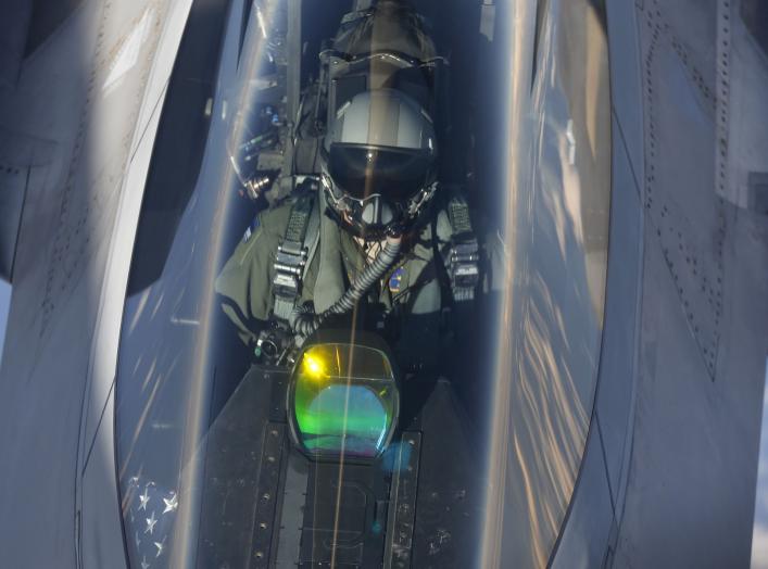 The head-up display of a F-22 Raptor fighter jet reflects the sun light as a pilot of the 95th Fighter Squadron from Tyndall, Florida is seen during refuelling by a KC-135 Stratotanker from the 100th Air Refueling Wing at the Royal Air Force Base in Milde