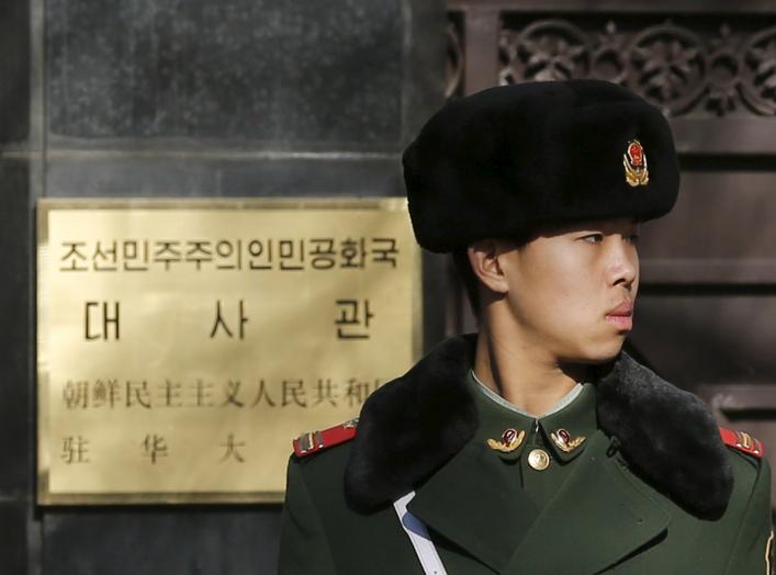 A paramilitary solider stands guard at the main gate of North Korea's embassy in Beijing January 6, 2016. North Korea said it had successfully conducted a test of a miniaturised hydrogen nuclear device on Wednesday morning.