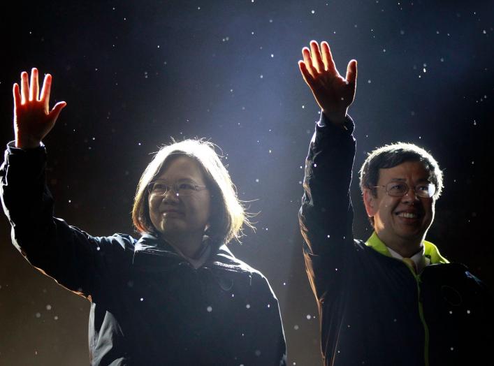 Taiwan's Democratic Progressive Party (DPP) Chairperson and presidential candidate Tsai Ing-wen (L) and vice presidential candidate Chen Chien-jen greet supporters as they take the stage during a final campaign rally ahead of the elections in Taipei, Taiw