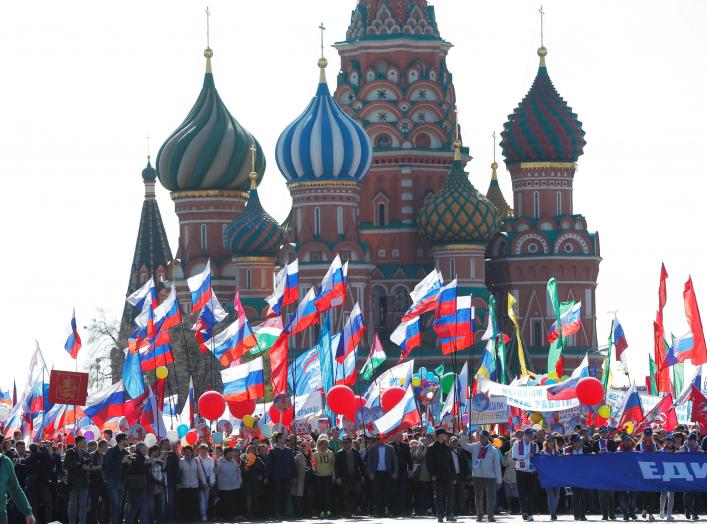 People walk with flags at Red Square during a May Day rally in Moscow, Russia, May 1, 2016. REUTERS/Maxim Zmeyev
