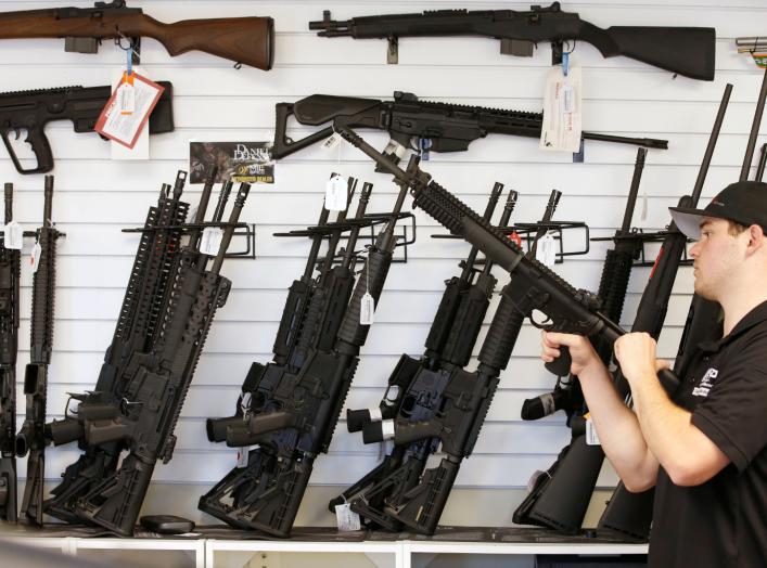 Salesman Ryan Martinez clears the chamber of an AR-15 at the "Ready Gunner" gun store In Provo, Utah, U.S. in Provo, Utah, U.S., June 21, 2016. REUTERS/George Frey