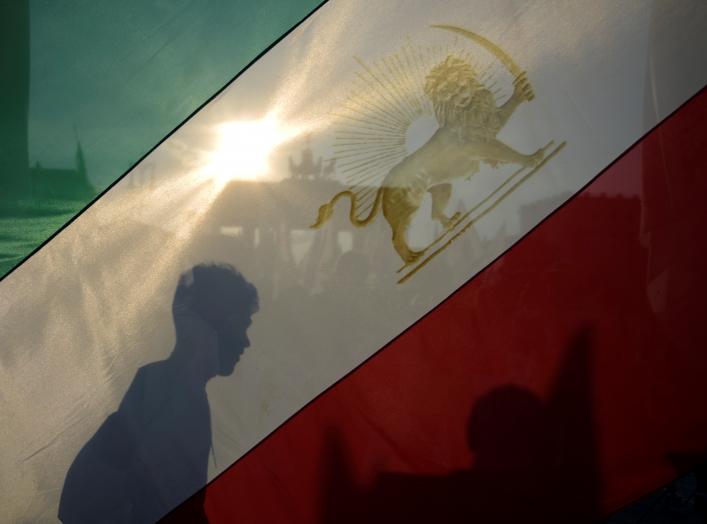 Activists hold flags during a demonstration against executions in Iran, in front of Brandenburg Gate in Berlin, Germany September 3, 2016. REUTERS/Stefanie Loos