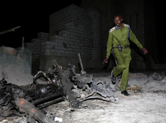 A Somali policeman inspects the scene of a suicide car explosion near the parliament in the capital Mogadishu, November 5, 2016. REUTERS/Feisal Oma