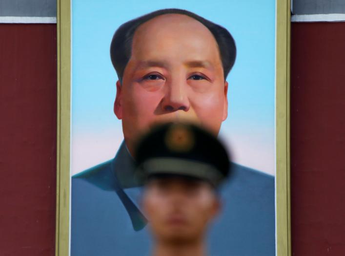 A paramilitary policeman stands guard under a giant portrait of late Chinese Chairman Mao Zedong at the Tiananmen gate in Beijing, China July 14, 2017. REUTERS/Damir Sagolj