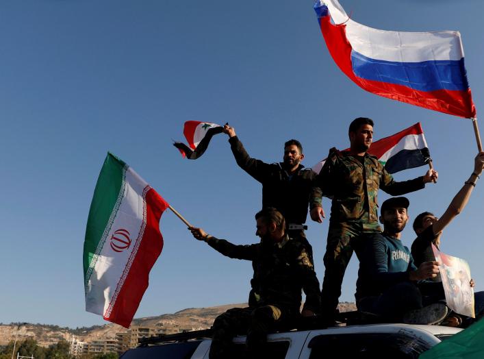 Syrians wave Iranian, Russian and Syrian flags during a protest against U.S.-led air strikes in Damascus,Syria April 14,2018.REUTERS/ Omar Sanadiki TPX IMAGES OF THE DAY