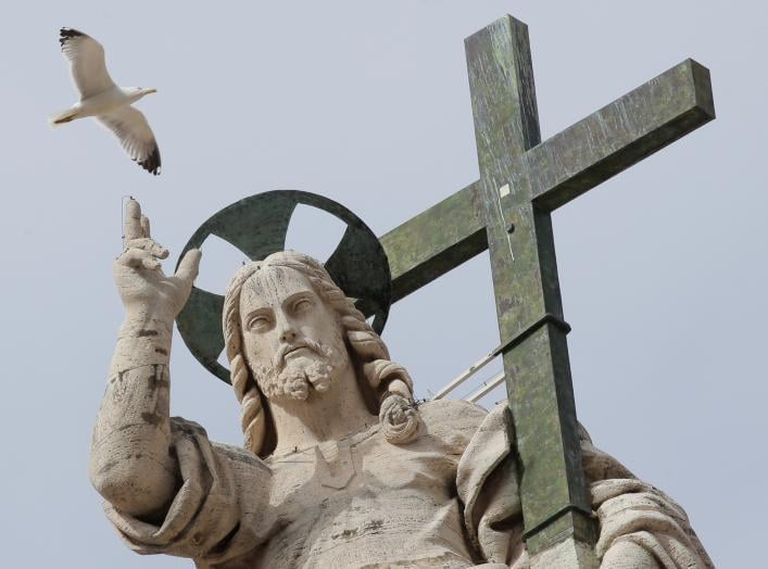 A seagull flies next to the statue of Jesus Christ during Pope Francis' Wednesday general audience in Saint Peter's square at the Vatican, April 18, 2018. REUTERS/Max Rossi