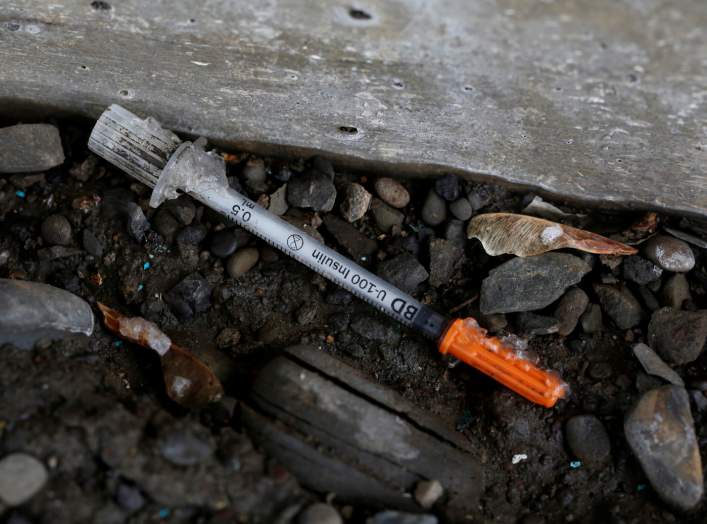 A discarded syringe is seen under a bridge on Lester Avenue in Johnson City, New York, U.S., April 7, 2018. Picture taken April 7, 2018. REUTERS/Andrew Kelly