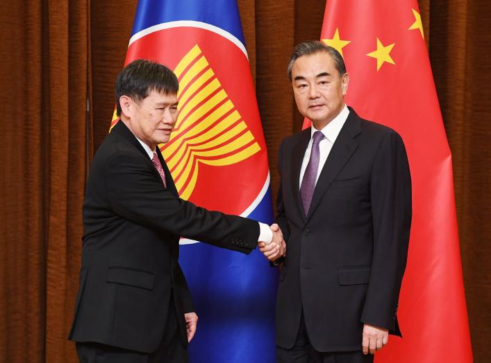 Association of South East Asian Nations (ASEAN) Secretary-General Lim Jock Hoi (L) is greeted by Chinese Foreign Minister Wang Yi before a meeting at the Foreign Ministry in Beijing, China, June 12, 2018. Greg Baker/Pool via Reuters