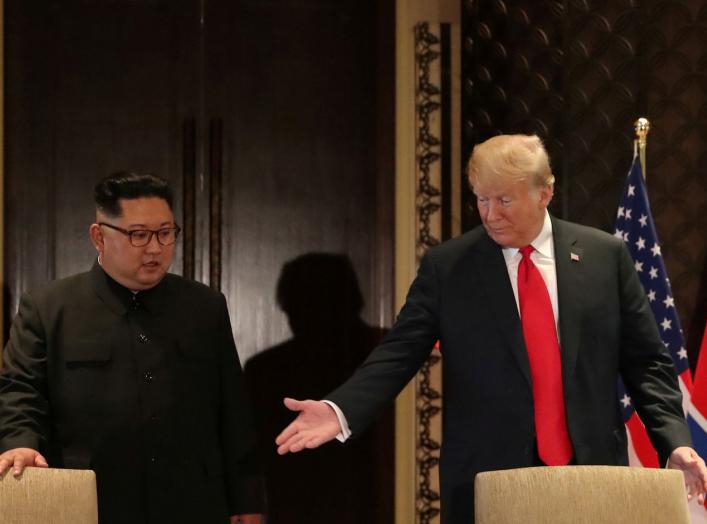 U.S. President Donald Trump and North Korea's leader Kim Jong Un arrive to sign a document to acknowledge the progress of the talks and pledge to keep momentum going, after their summit at the Capella Hotel on Sentosa island in Singapore June 12, 2018. RE