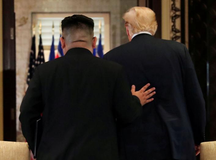 U.S. President Donald Trump and North Korea's leader Kim Jong Un leave after signing documents that acknowledge the progress of the talks and pledge to keep momentum going, after their summit at the Capella Hotel on Sentosa island in Singapore June 12, 20