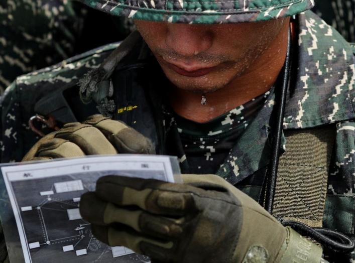 A bead of sweat is dripping off from a Taiwanese Marine from Underwater Demolition Company, Amphibious Reconnaissance Patrol Unit (ARP), before a night-time landing training, in Kaohsiung, Taiwan July 23, 2018. REUTERS/Tyrone Siu