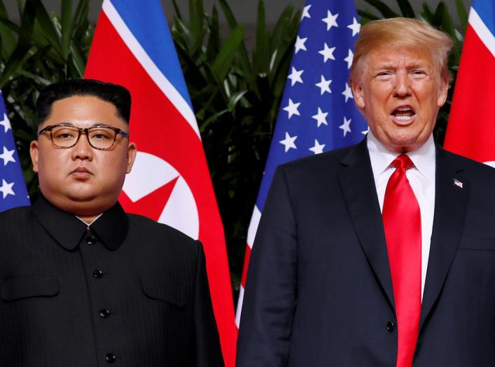 FILE PHOTO: U.S. President Donald Trump and North Korean leader Kim Jong Un react at the Capella Hotel on Sentosa island in Singapore June 12, 2018. REUTERS/Jonathan Ernst/File Photo