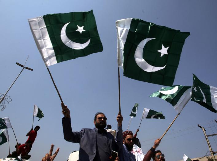 People carry national flags as they celebrate, after Pakistan shot down two Indian military aircrafts, in Lahore, Pakistan February 27, 2019. REUTERS/Mohsin Raza