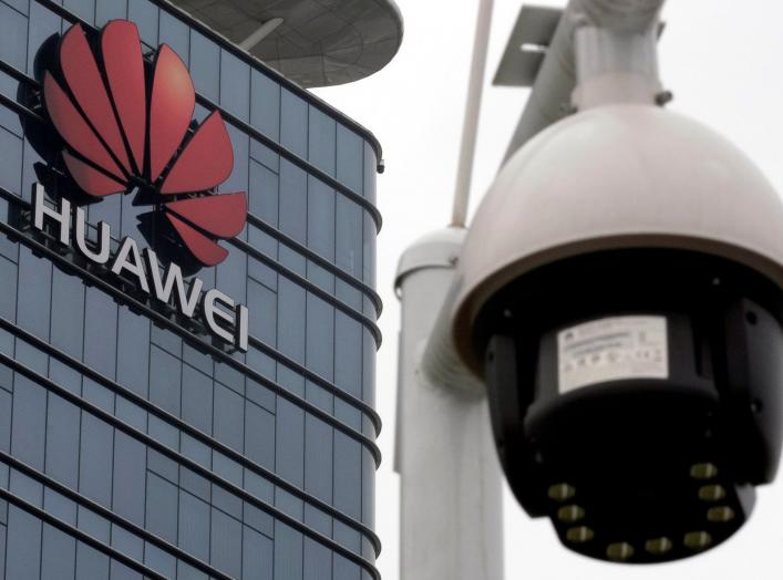 FILE PHOTO: A surveillance camera is seen in front of the Huawei logo outside its factory campus in Dongguan, Guangdong province, China, March 25, 2019. REUTERS/Tyrone Siu/File Photo