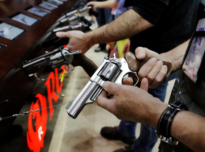 A man handles a Ruger revolver during the National Rifle Association (NRA) annual meeting in Indianapolis, Indiana, U.S., April 27, 2019. REUTERS/Lucas Jackson