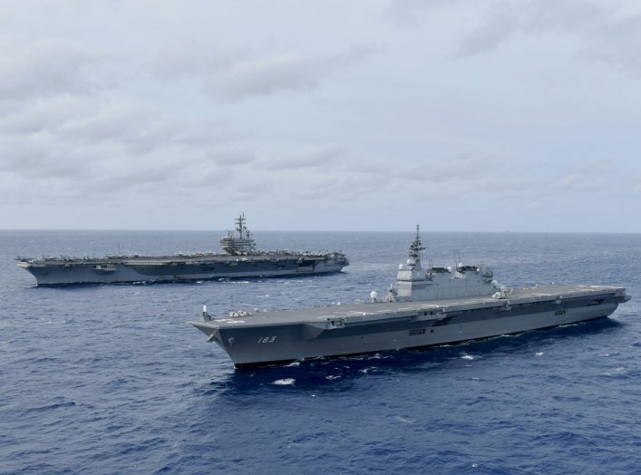 The Navy's forward-deployed aircraft carrier USS Ronald Reagan operates with the Japan Maritime Self-Defense Force helicopter carrier JS Izumo (R) in South China Sea June 11, 2019. Picture taken June 11, 2019. Courtesy JMSDF/U.S. Navy/Handout via REUTERS