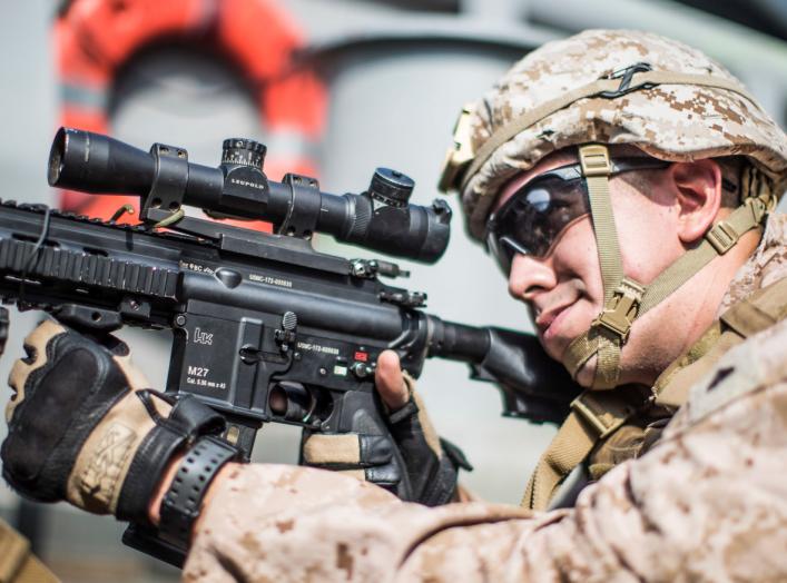 A U.S. Marine Corps rifleman with Kilo Company, Battalion Landing Team 3/5, provides security with an M27 Infantry Automatic Rifle on aboard the amphibious assault ship USS Boxer (LHD 4) during its transit through Strait of Hormuz in Gulf of Oman