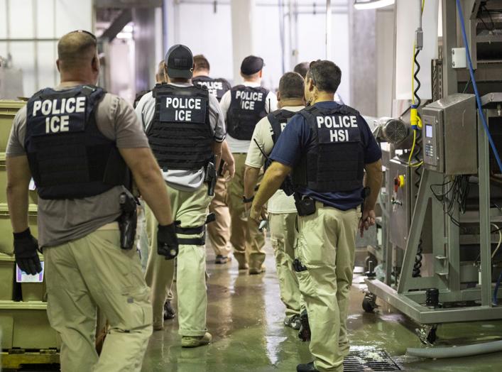 Homeland Security Investigations (HSI) officers from Immigration and Customs Enforcement (ICE) look on after executing search warrants and making some arrests at an agricultural processing facility in Canton, Mississippi, U.S. in this August 7, 2019 hando