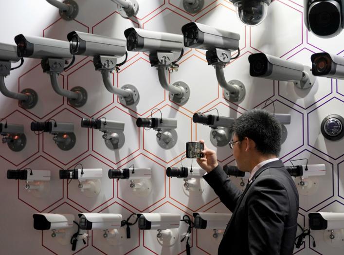 A man looks at surveillance cameras at the annual Huawei Connect event in Shanghai, China September 18, 2019. REUTERS/Aly Song