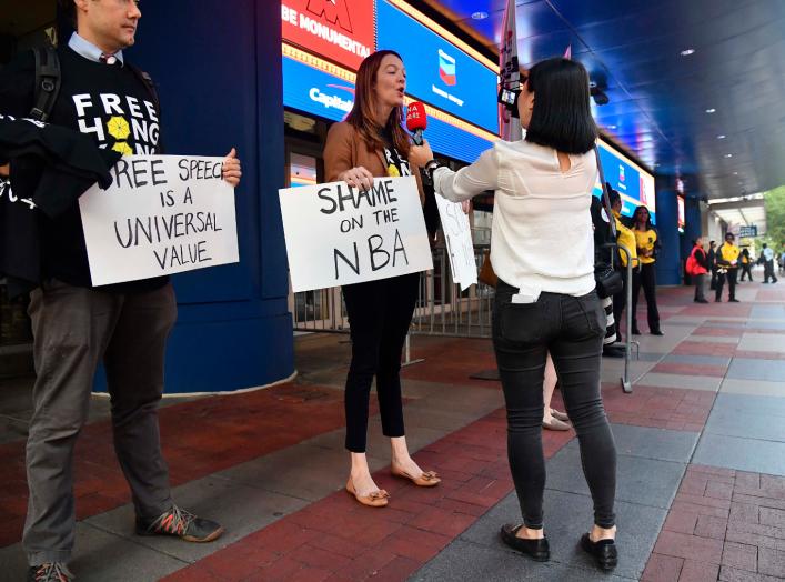 Oct 9, 2019; Washington, DC, USA; Activists hold signs in support of Hong Kong before the game between the Washington Wizards and the Guangzhou Loong-Lions at Capital One Arena. Mandatory Credit: Brad Mills-USA TODAY Sports