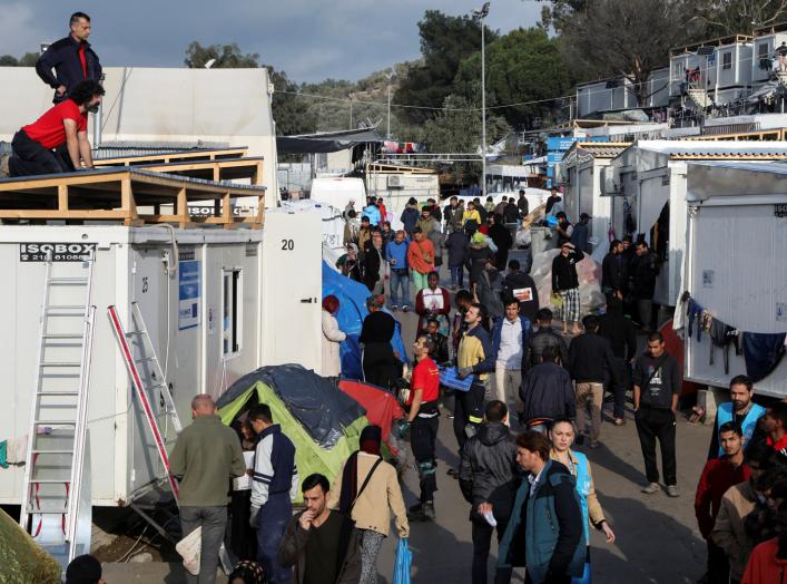 Refugees and migrants make their way inside the Moria camp, on the island of Lesbos, Greece, November 27, 2019. REUTERS/Elias Marcou