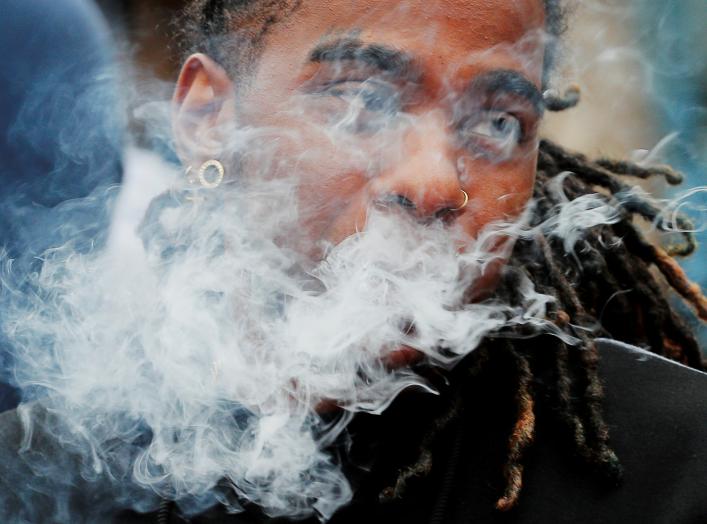 A demonstrator vapes during a protest at the Massachusetts State House against the state’s four-month ban of all vaping product sales in Boston, Massachusetts, U.S., October 3, 2019. REUTERS/Brian Snyder