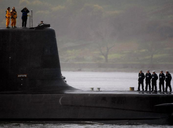 Crew from HMS Astute, the first of the biggest hunter-killer submarines to be ordered by Britain's Royal Navy, look out as they sail into the River Clyde and up the Gareloch to her new home at HM Naval Base Clyde in Faslane near Glasgow, Scotland November